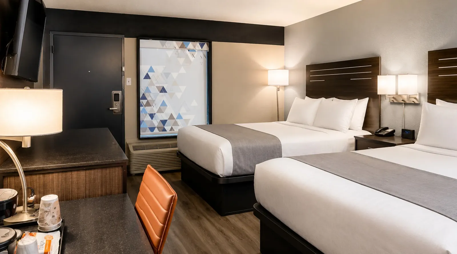 Spacious double queen guest room at Lx Hotel Manchester TN with plush bedding and modern furnishings