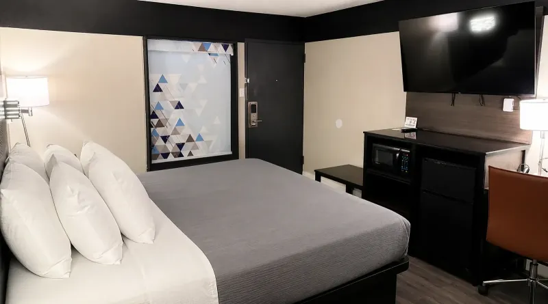 Casual king room at Lx Hotel Manchester TN with ensuite bathroom, microwave, and refrigerator